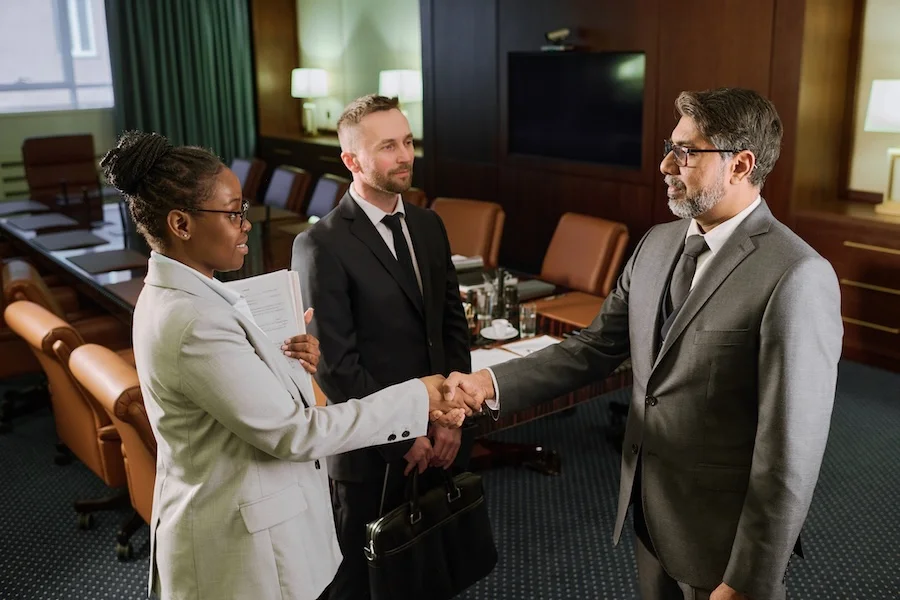 https://concertium.com/wp-content/uploads/2025/02/Confident_Colleagues_Shaking_Hands.webp