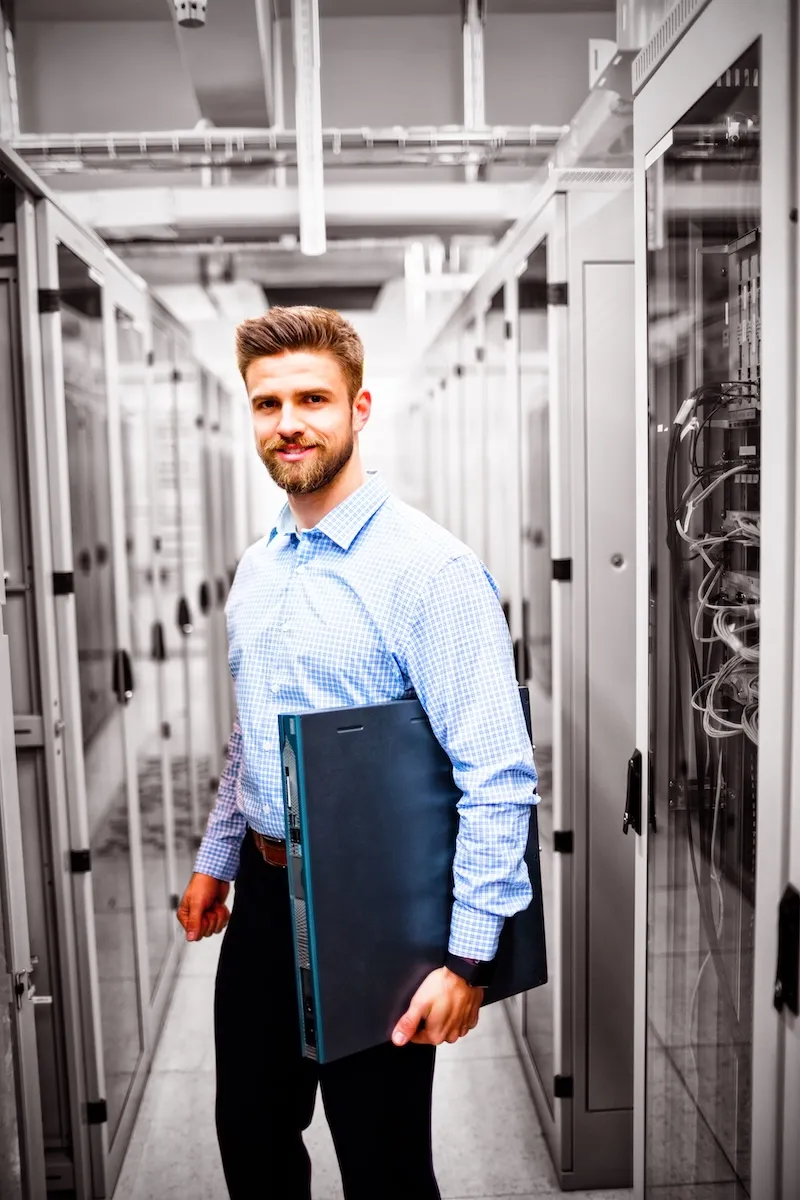 https://concertium.com/wp-content/uploads/2025/05/technician_holding_server.webp